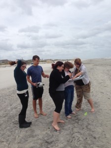 Students preparing to collect sand and water samples. 